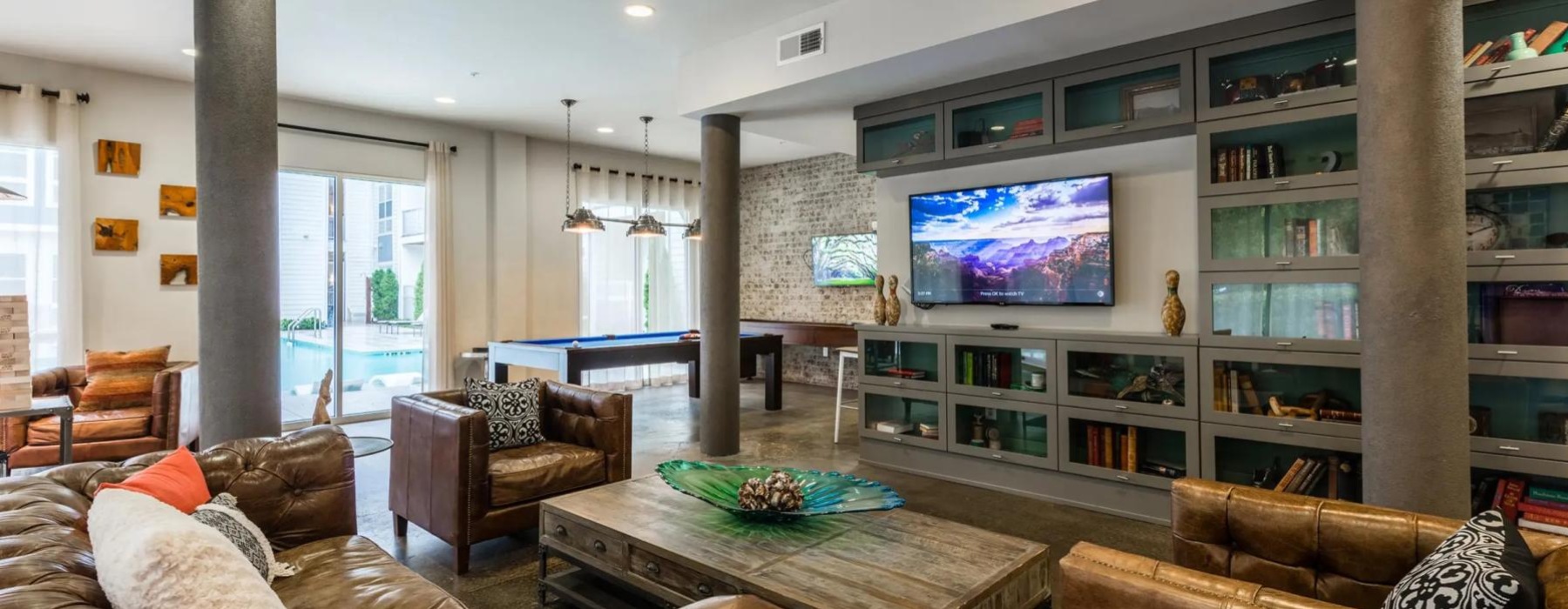 a spacious room with a tv and couches