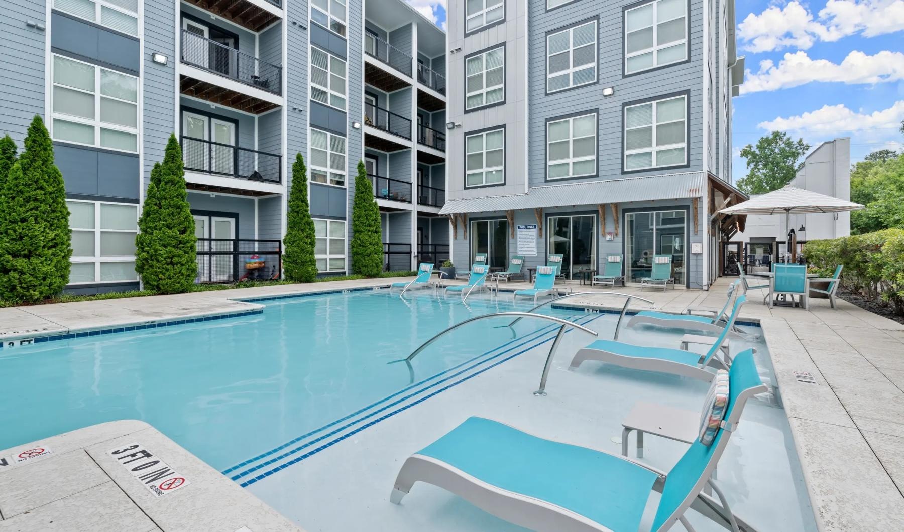 a swimming pool in front of a building