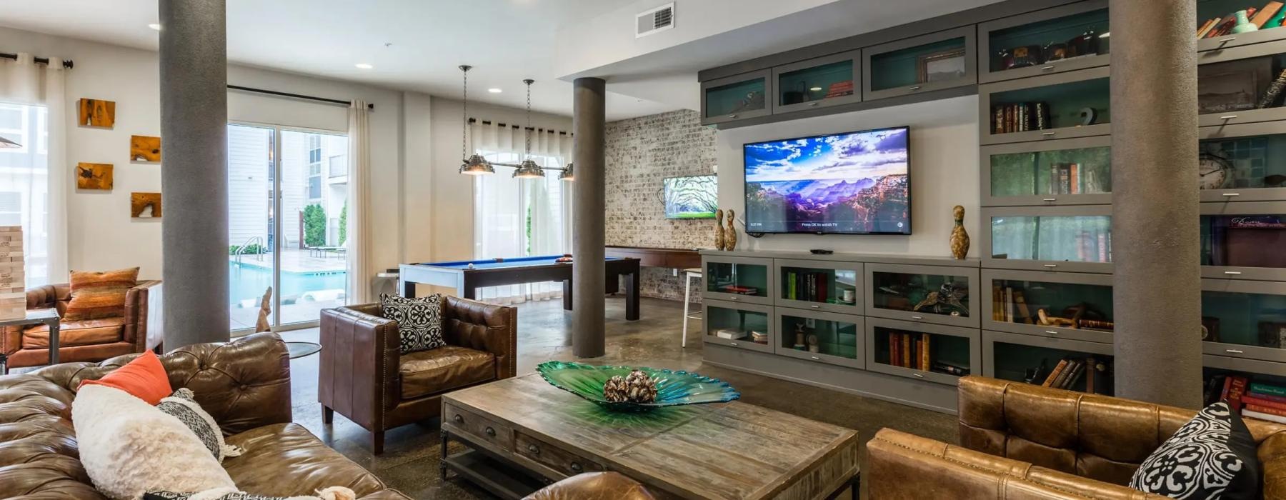 a spacious room with a tv and couches